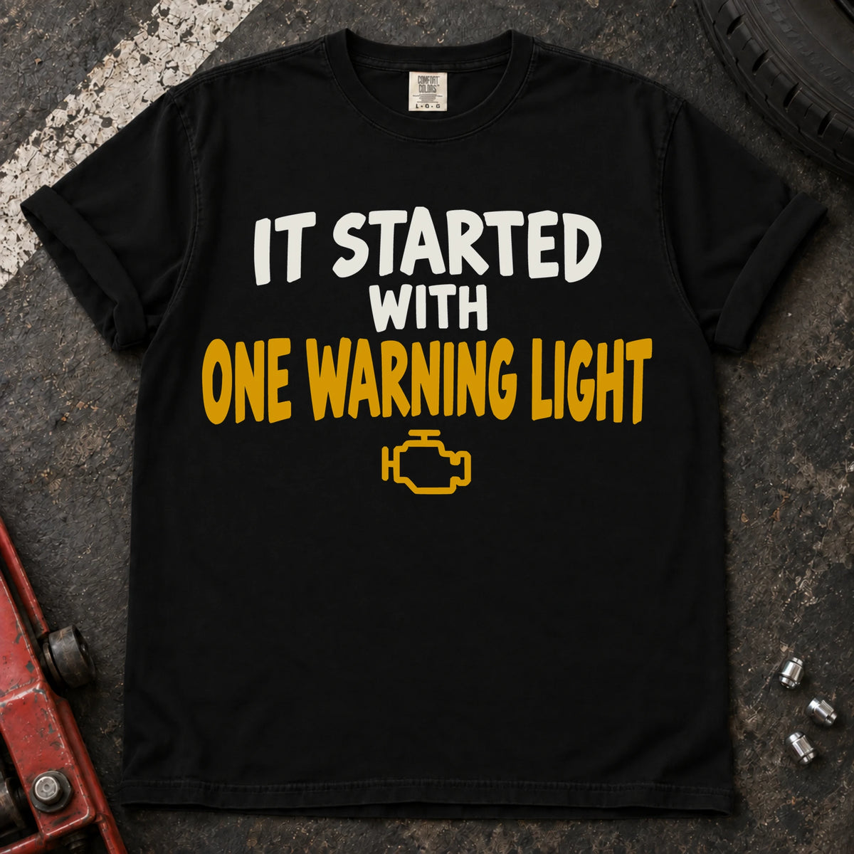 Black T-shirt reading 'It started with one warning light' above a check-engine symbol.