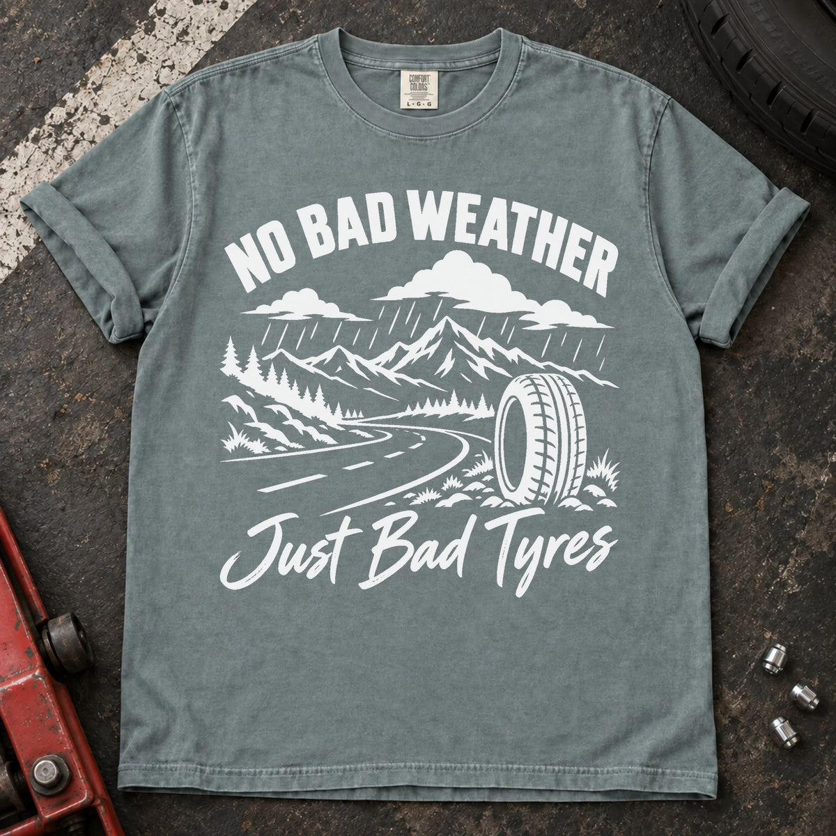 Bay car enthusiast T-shirt. A rainy mountain road and tire explain no bad weather, just bad tyres.