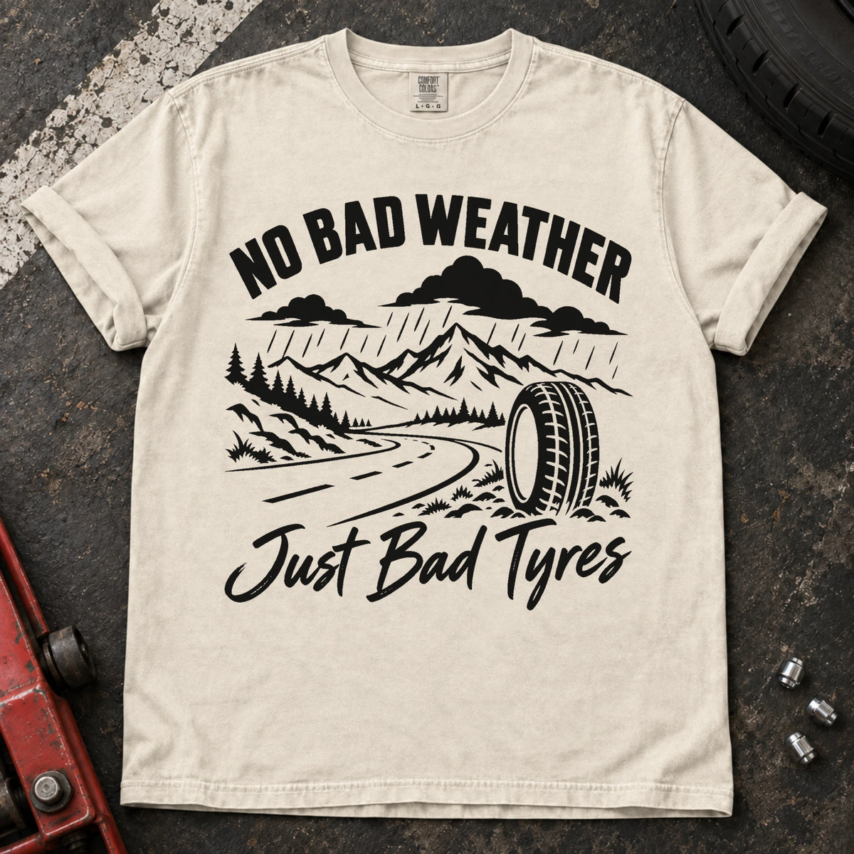 Ivory car enthusiast T-shirt. A rainy mountain road and tire explain no bad weather, just bad tyres.