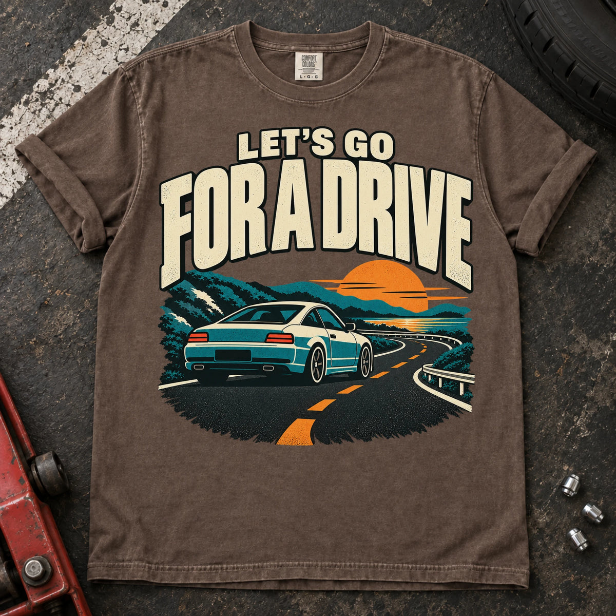 Espresso car enthusiast T-shirt. A car cruises a sunset mountain road under let's go for a drive.