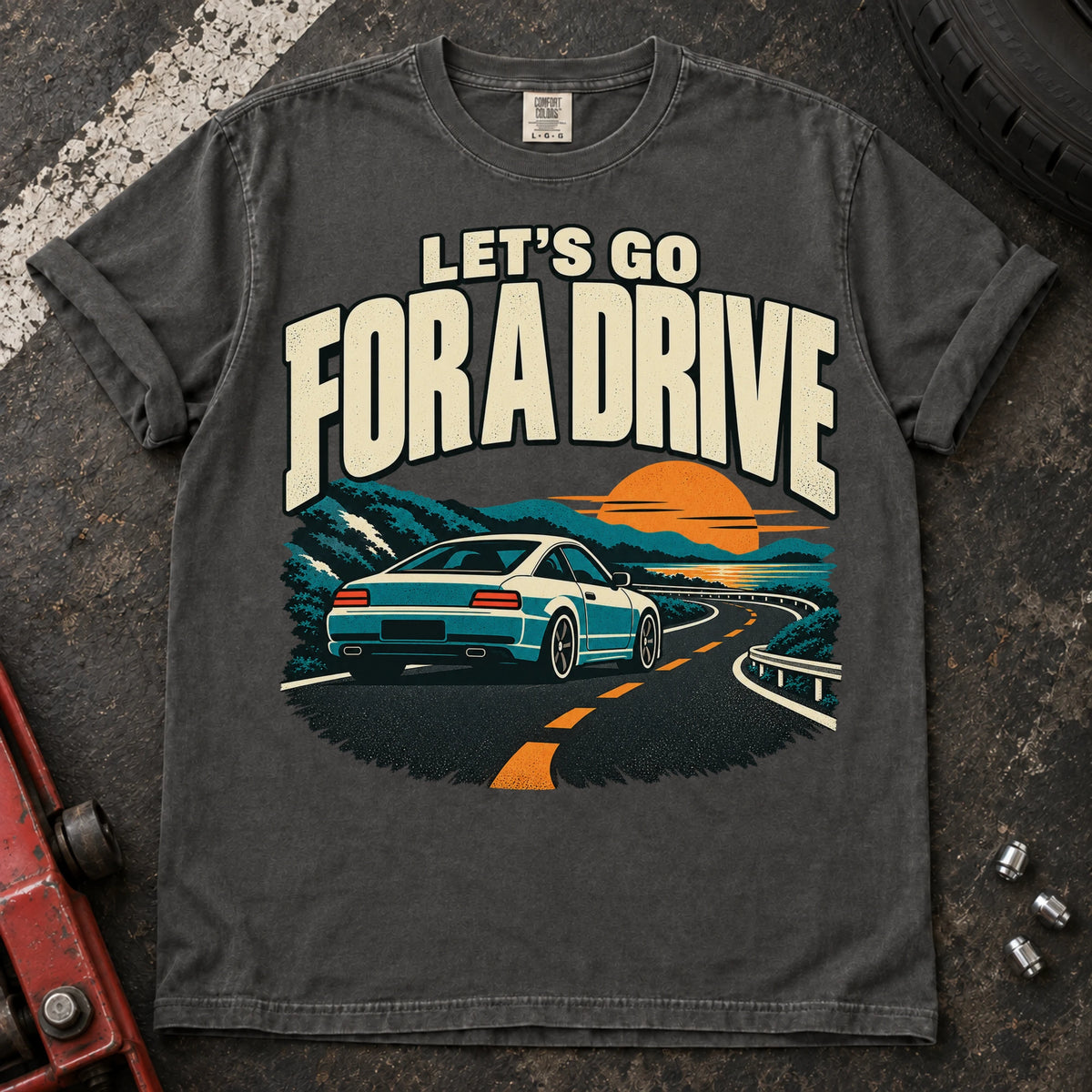Pepper car enthusiast T-shirt. A car cruises a sunset mountain road under let's go for a drive.