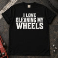 Black T-shirt with bold lettering reading 'I love cleaning my wheels'.