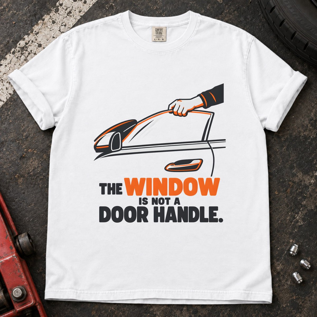 White T-shirt showing a hand reaching through a car window with 'The window is not a door handle'.