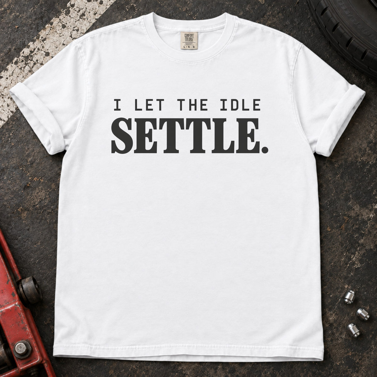 White T-shirt with spaced lettering reading 'I let the idle settle'.
