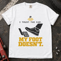 White T-shirt showing a shoe near a pedal and a parking-assist symbol with 'I trust the car. My foot doesn't'.