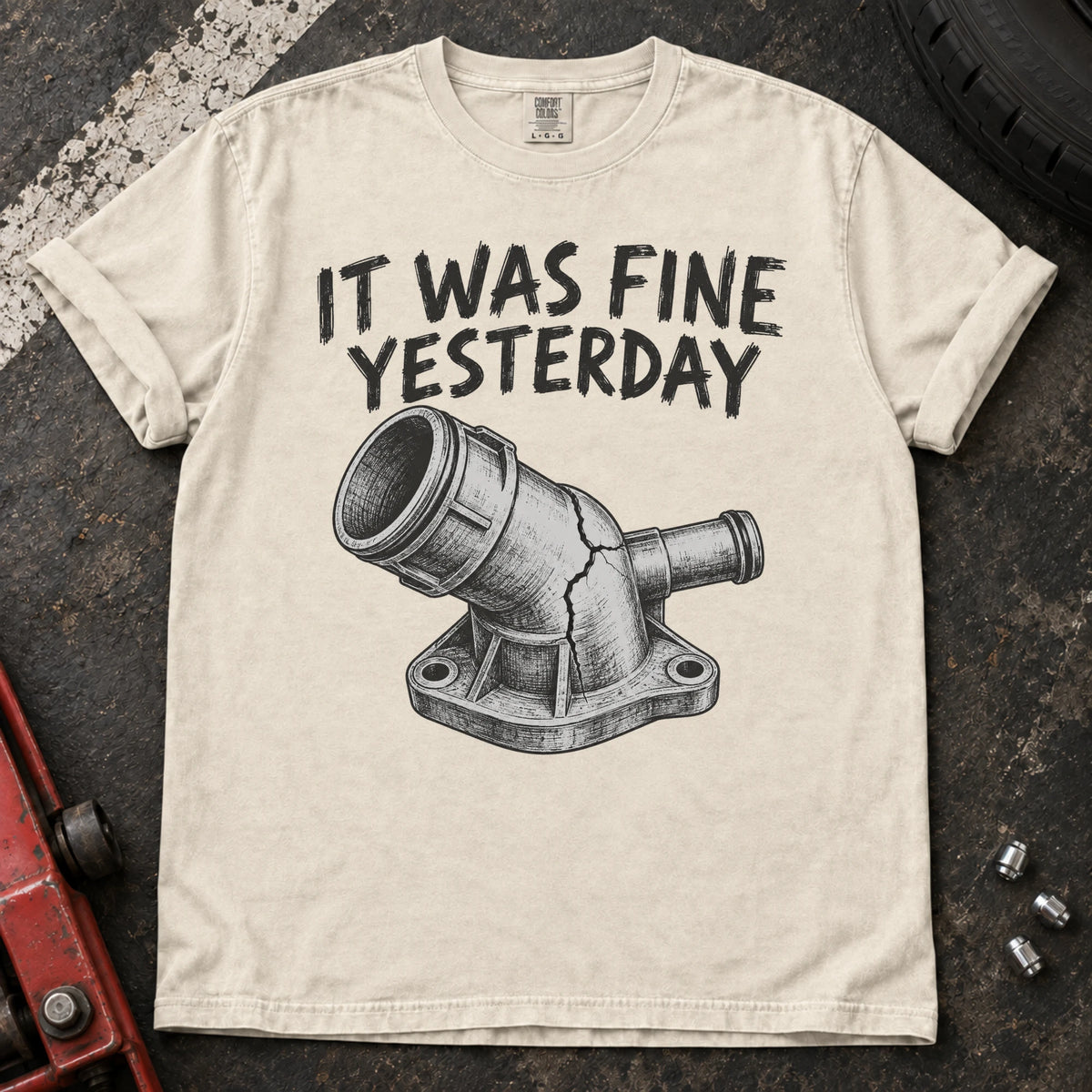 Ivory car enthusiast T-shirt. A cracked coolant fitting proves it was fine yesterday.